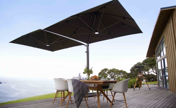 Resort table with big umberalla next to open sea