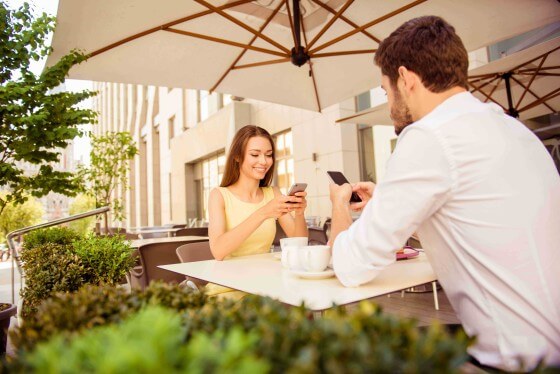 Two people looking at their phones
