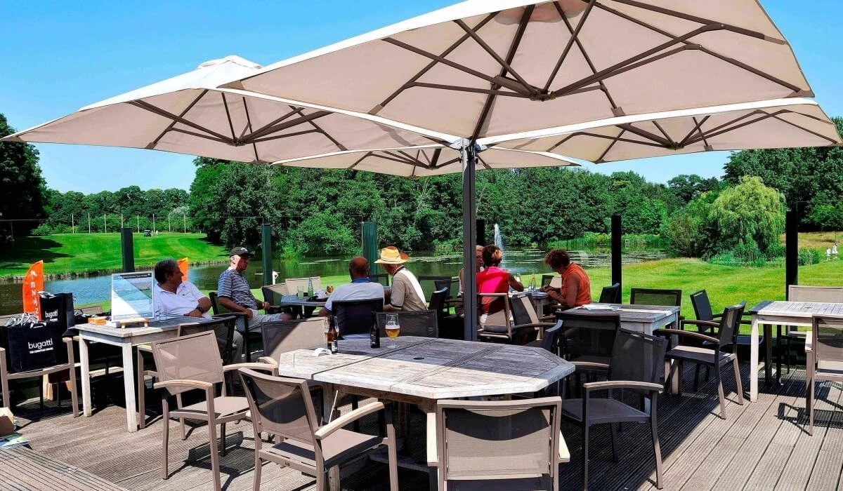 People dining under outdoor shade