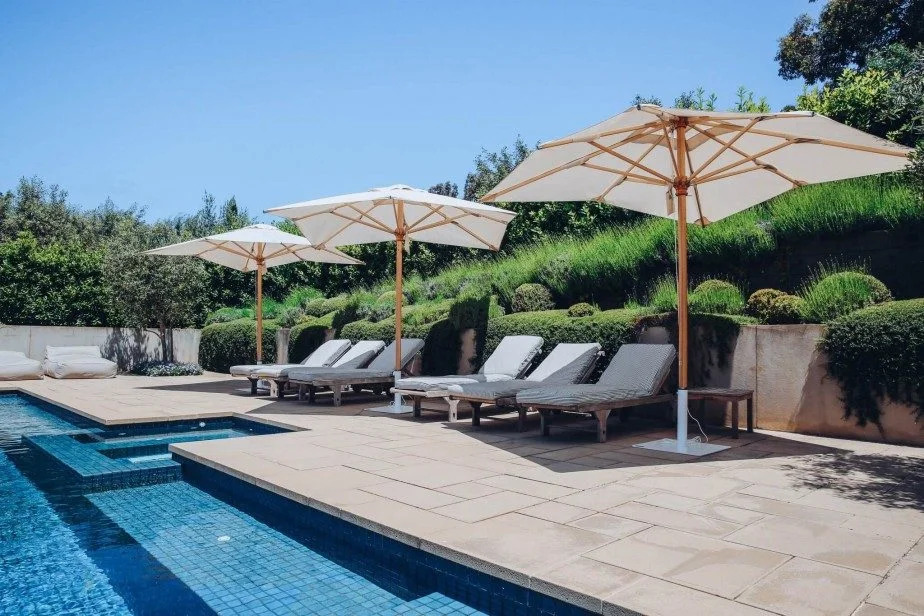 Umbrellas near pool on backyard