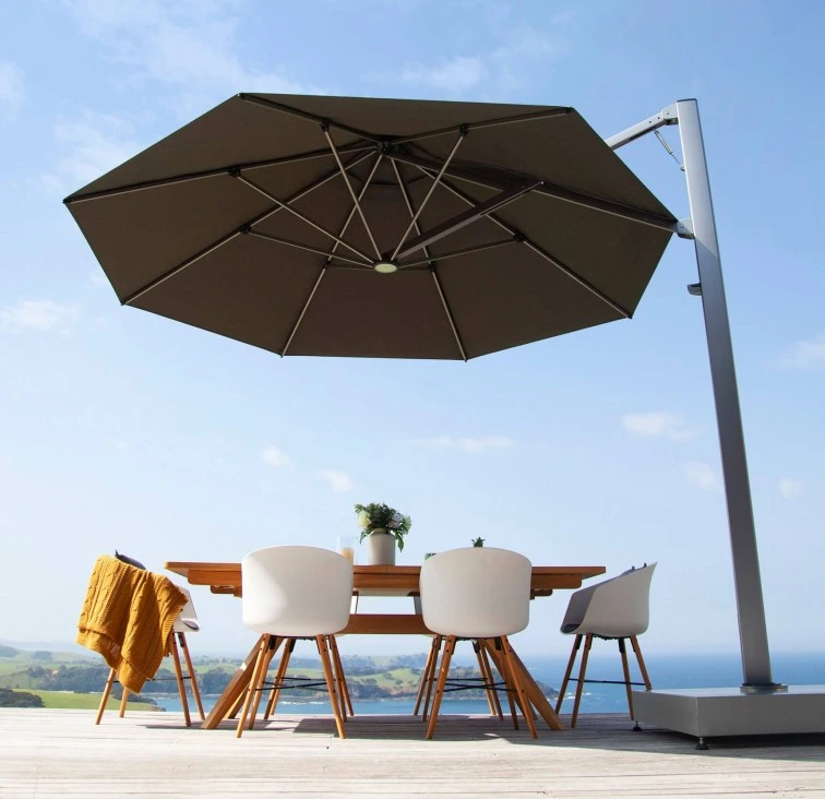 Black Umbrella on top of a table next to landscape view