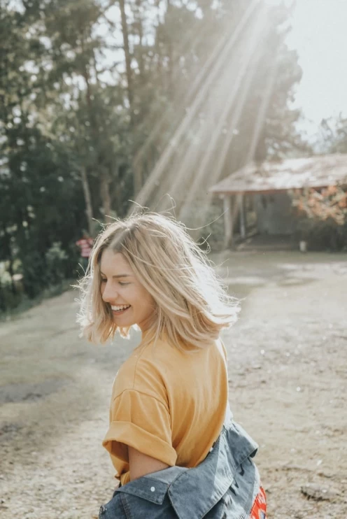 Girl with sun rays on head shot