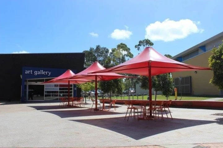 Three Flexshade Centre Pole Umbrellas in red